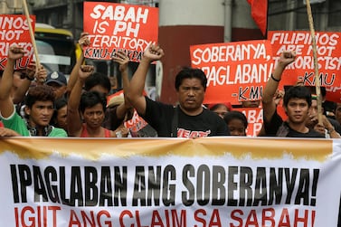 Protesters attend a rally near the Presidential Palace in Manila, Philippines in 2013. Seven years ago, hundreds of militants landed in Sabah, leading to deadly clashes with Malaysian security personnel. AP Photo
