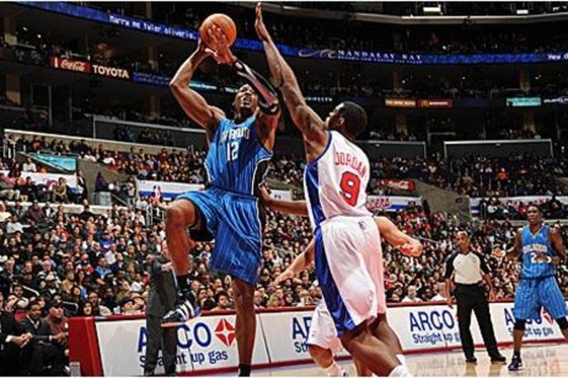 Orlando's Dwight Howard, No 12, shoots over DeAndre Jordan of the Clippers.