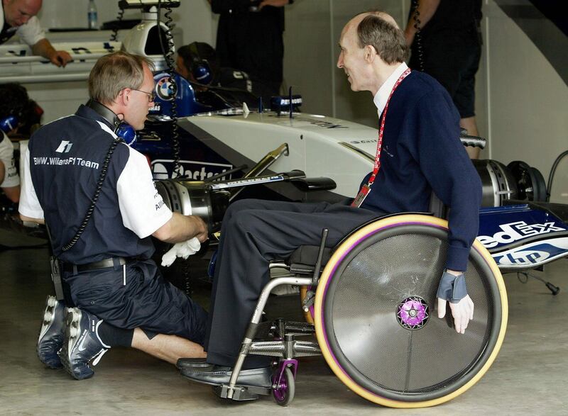 Frank Williams, right, the then head  BMW-Williams Formula One team, chats with one of his technicians after the free practice round at the Nuerburgring circuit in Germany in 2003. EPA