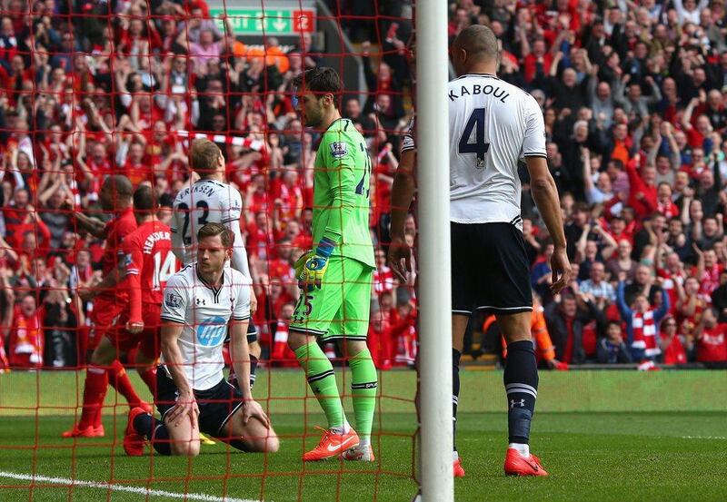 Younes Kaboul of Tottenham Hotspur and his team-mates react after scoring an own goal during their 4-0 loss to Liverpool FC at Anfield on Sunday. Alex Livesey / Getty Images / March 30, 2014