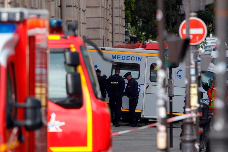Police officers stand next to an ambulance near Paris prefecture de police (police headquarters) after four officers were killed in a knife attack. AFP