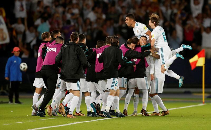 Real Madrid’s Cristiano Ronaldo is mobbed by his team mates after scoring the first goal. Matthew Childs / Reuters