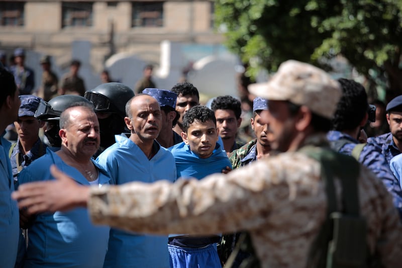 Police guard men convicted over the killing of a senior Houthi official before their execution at Tahrir Square in Sanaa, Yemen, on September 18. AP Photo