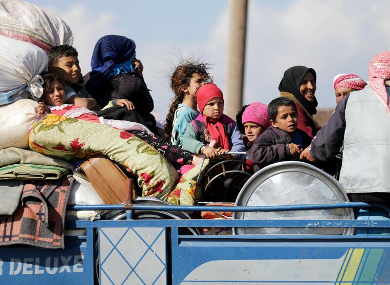 Internally displaced people ride on the back of a truck with their belongings in the town of Inab, eastern Afrin, Syria March 12, 2018. REUTERS/Khalil Ashawi     TPX IMAGES OF THE DAY