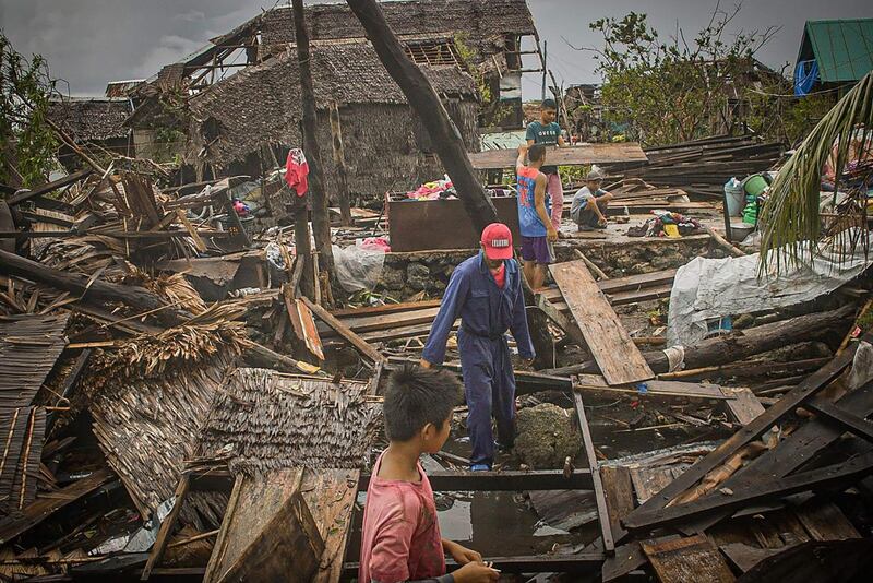 Residents try to salvage belongings in San Policarpio town, Eastern Samar province. AFP