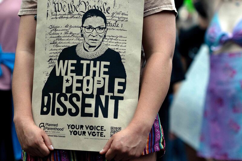 A demonstrator carries a print of women’s rights champion Ginsburg as abortion rights activists march in protest against the overturning of the Roe v Wade verdict. AFP