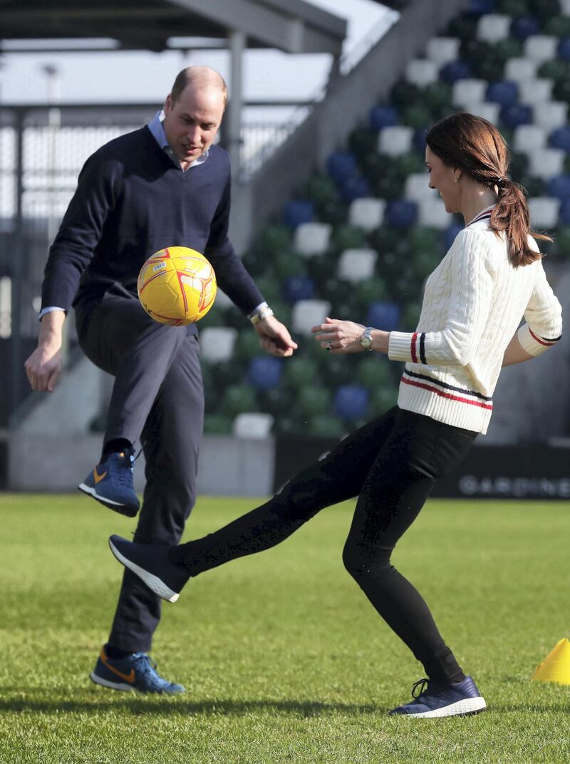 BELFAST, NORTHERN IRELAND - FEBRUARY 27:  Prince William Duke of Cambridge and Catherine, Duchess of Cambridge, play football as they visit the National Stadium in Belfast, home of the Irish Football Association on February 27, 2019 in Belfast, Northern Ireland. Prince William last visited Belfast in October 2017 without his wife, Catherine, Duchess of Cambridge, who was then pregnant with the couple's third child. This time the couple concentrate on the young people of Northern Ireland. Their engagements include a visit to Windsor Park Stadium, home of the Irish Football Association, activities at the Roscor Youth Village in Fermanagh, a party  at the Belfast Empire Hall, Cinemagic -a charity that uses film, television and digital technologies to inspire young people and finally dropping in on a SureStart early years programme. (Photo by Kelvin Boyes -  Pool/Getty Images)