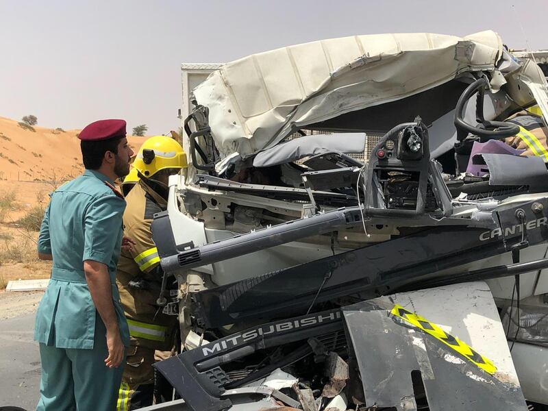 An officer inspects a vehicle in which three people died. Courtesy: UAQ Police