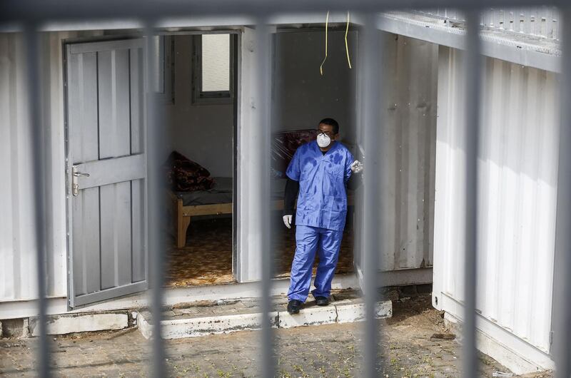 A health worker wearing a protective mask stands at a quarantine zone installed by the Palestinian health ministry in the Gaza Strip. AFP