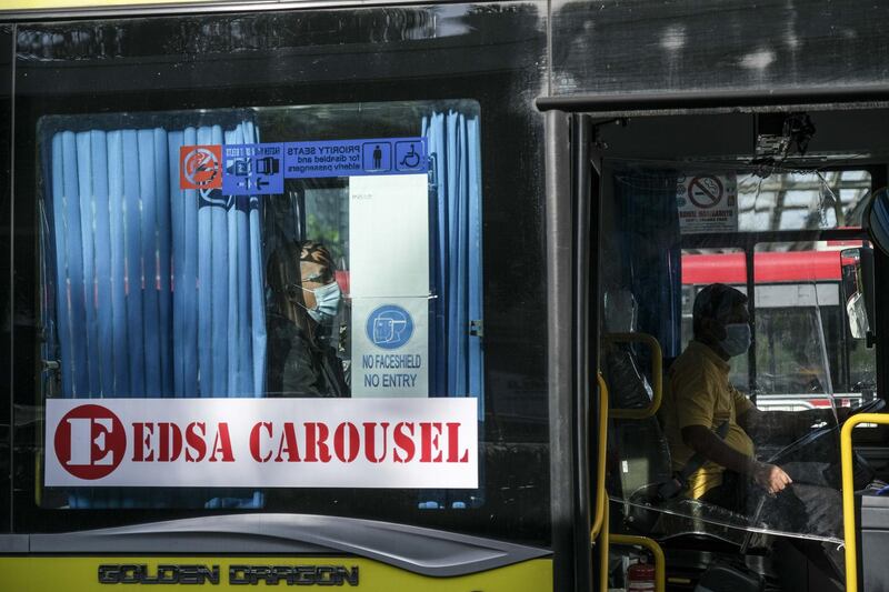 A passenger sits inside a bus at a transport centre at the SM Mall of Asia complex in Pasay City, Metro Manila, Philippines. Bloomberg