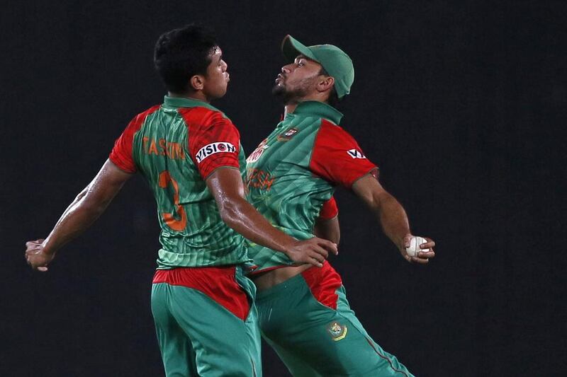 Taskin Ahmed and Mashrafe Mortaza, right, of Bangladesh celebrate during a T20 international match against Pakistan last month. AM Ahad / AP / April 24, 2015