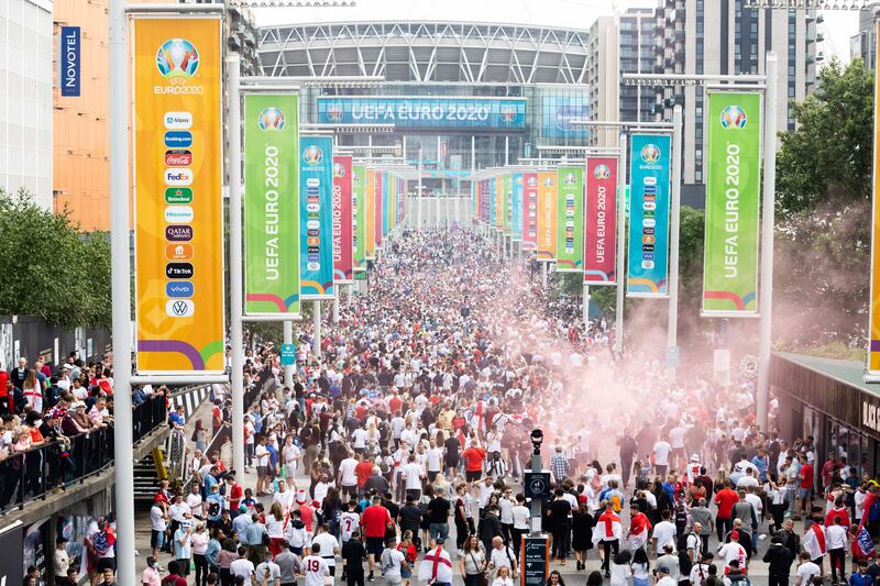 Fans arrive at Wembley stadium ahead of the Euros football final between England and Italy.