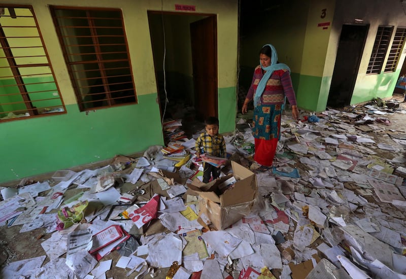 Books lie scattered at the Rajdhani Public School which was vandalized in Tuesday's violence at Shiv Vihar in New Delhi, India.  AP