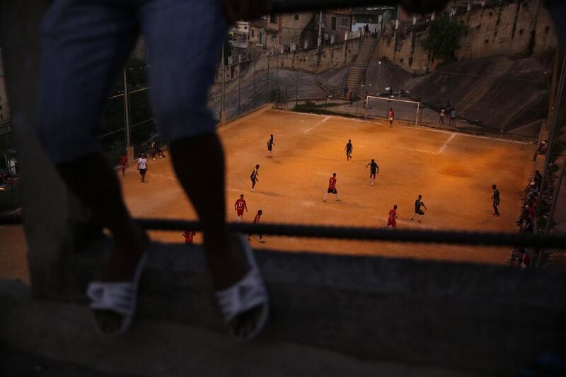 Youths play football during a tournament at the San Carlos slum in Rio de Janeiro. Pilar Olivares / Reuters