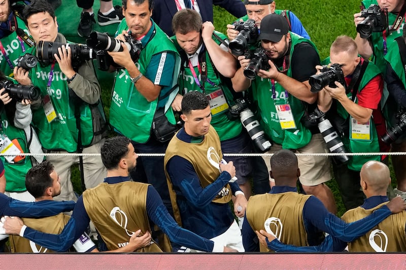 Phtographers surround Portugal subsitute Cristiano Ronaldo before the match. AP