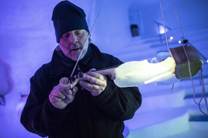 US artist Tim Linhart works on an ice violin in the "Ice Dome" on Presena Glacier, Tonale Pass, near Trento in northern Italy. AFP