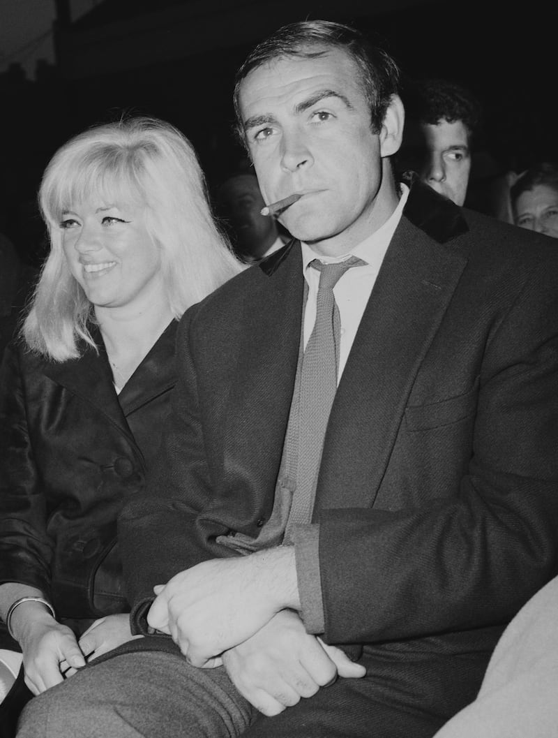 Scottish actor Sean Connery and actress Diana Dors await the Heavyweight Champion of the World fight between Henry Cooper and Muhammad Ali at Arsenal Stadium, London, 21st May 1966. (Photo by Central Press/Hulton Archive/Getty Images)