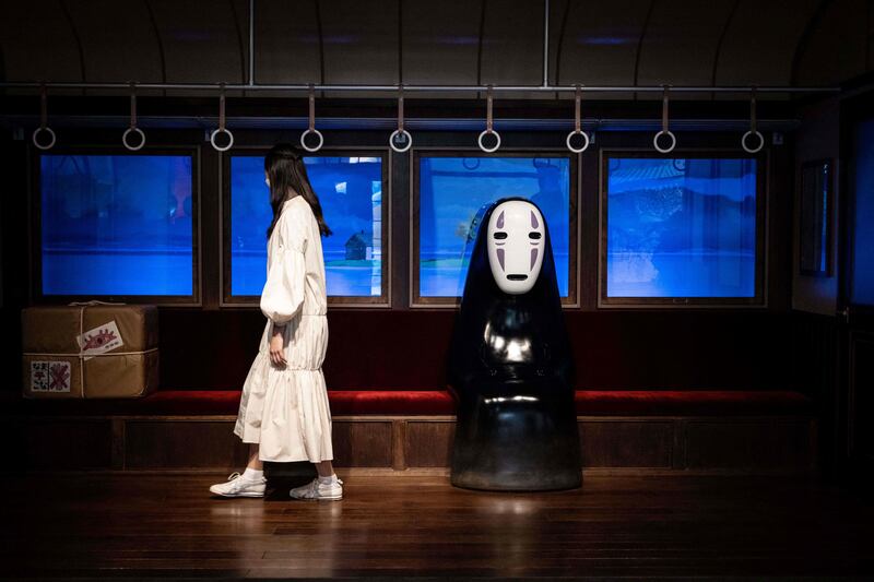 The character No Face is seated on a train from the film 'Spirited Away' at Ghibli Park. AFP