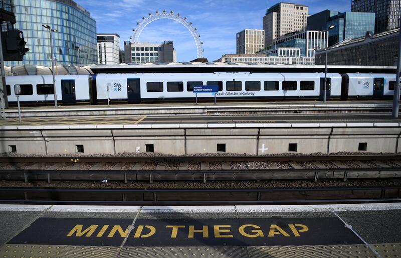 A train sits at an empty platform at Waterloo station in London. EPA