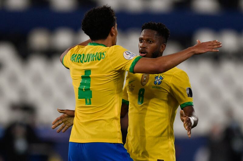 Brazil's Marquinhos (L) and Fred celebrate defeating Chile.