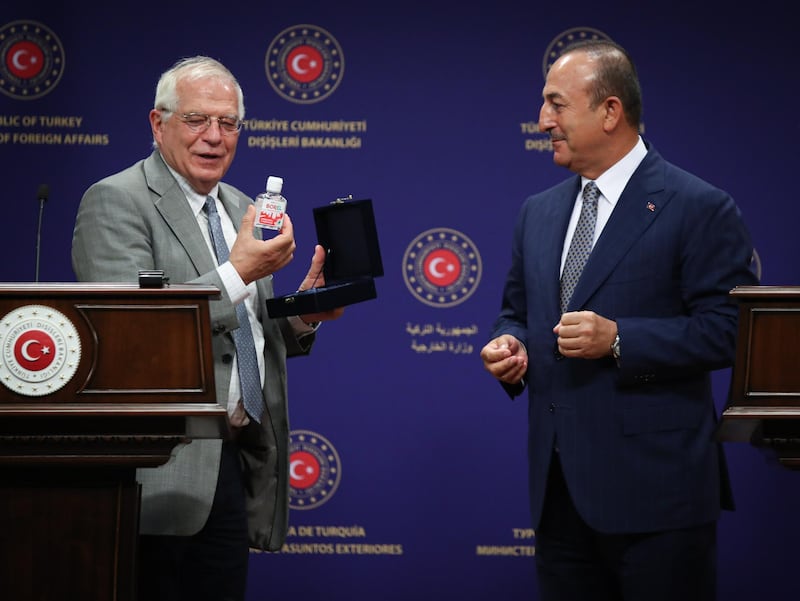 epa08531227 A handout photo made available by Turkish Foreign Ministry Press Office shows, Turkish Minister of Foreign Affairs Mevlut Cavusoglu (R) gives a hand sanitizier called 'Borel' as a present to High representative of European Union Josep Borrell (L) after their press conference  in Ankara, Turkey, 06 July 2020. Borrell is visiting Turkey amid increasing tensions between the two sides most recently over the conflict in Libya.  EPA/FATIH AKTAS /  Turkish Foreign Ministry Press Office HANDOUT  HANDOUT EDITORIAL USE ONLY/NO SALES