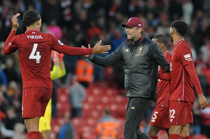 Liverpool manager Juergen Klopp congratulates Liverpool's Virgil van Dijk , left, after the English Premier League soccer match between Liverpool and Manchester City at Anfield stadium in Liverpool, England, Sunday, Oct. 7, 2018. (AP Photo/Rui Vieira)