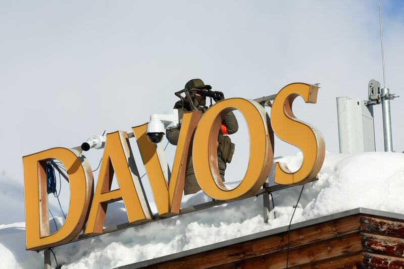 A police officer takes position on a roof ahead of the annual meeting of the World Economic Forum. Nearly 1,600 business leaders, as well as 60 heads of state and government, will gather at the Swiss resort this week. Reuters