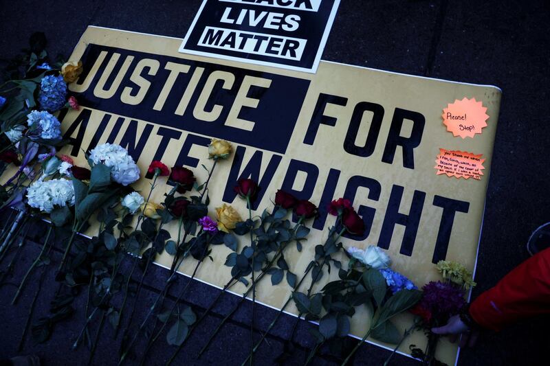 Flowers are laid on a sign as protesters rally outside the Brooklyn Center Police Department, days after Daunte Wright was shot and killed by a police officer, in Brooklyn Center, Minnesota, U.S. April 13, 2021. REUTERS/Leah Millis