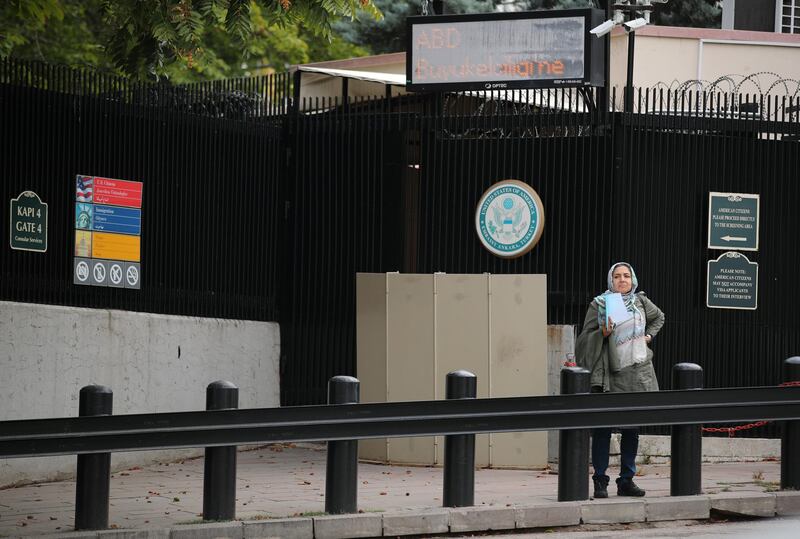 A woman waits in front of the visa application office entrance of the U.S. Embassy in Ankara, Turkey, October 9, 2017. REUTERS/Umit Bektas
