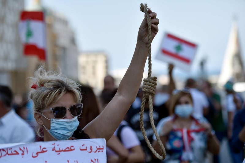 An anti-government protester carries a mock noose. EPA