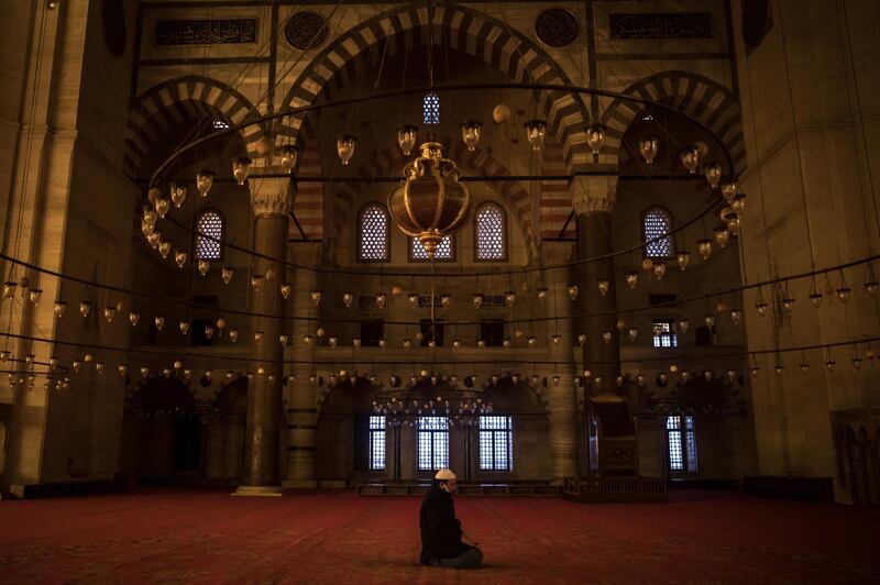 Davut Avci, the muezzin of Suleymaniye Mosque prays alone during the evening prayer on the first day of Ramadan and the second day of a four-day lockdown across Istanbul on April 24, 2020, in Istanbul, Turkey. Getty