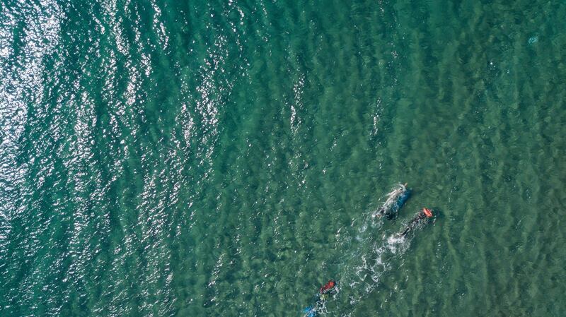 An aerial picture taken by drone shows Turkish free diver Birgul Erken swims underwater as  she attempts a record-breaking swim 165 metres underwater as the longest horizontal swimming underwater with one breath at Sokakagzi Beach in Canakkale, Turkey on Wednesday August 10. Erken managed to swim the distance but was denied the record after being touched mistakenly by a team member during the attempt. EPA