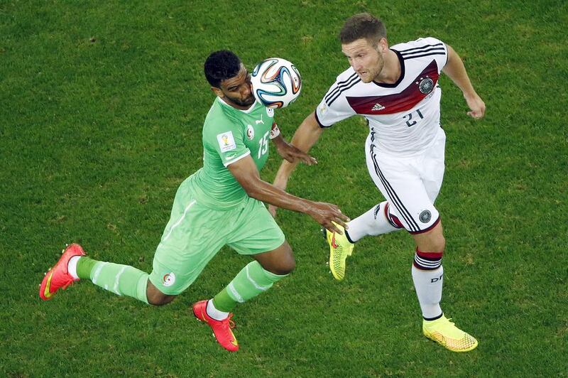 Germany's Shkodran Mustafi, right, and Algeria's El Arbi Hillel Soudani go for a header during the World Cup round of 16 soccer match between Germany and Algeria at the Estadio Beira-Rio in Porto Alegre, Brazil, Monday, June 30, 2014. Fabrizio Bensch / AP Photo