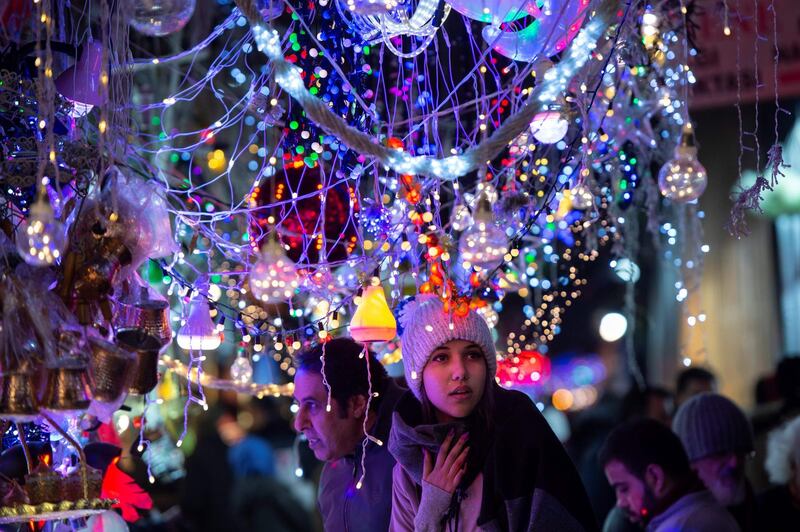 A woman looks at Christmas decorations at Eminonu Bazaar. AFP