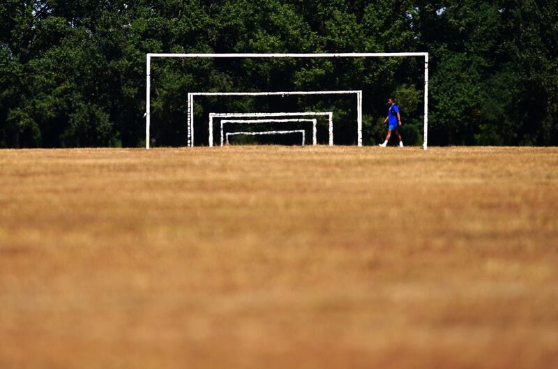Dry grass on the football pitches at Hackney Marshes in east London. PA