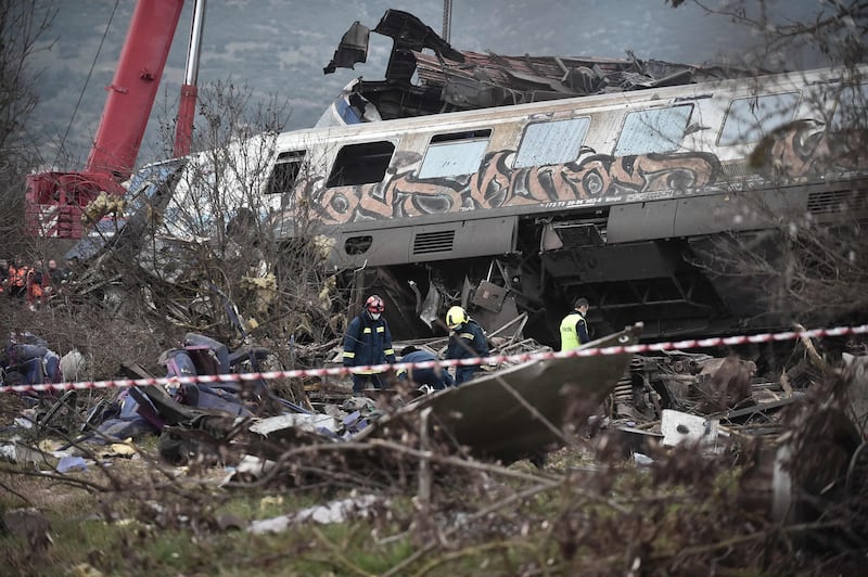 Police and emergency crew search for trapped passengers inside the wreackage. AFP