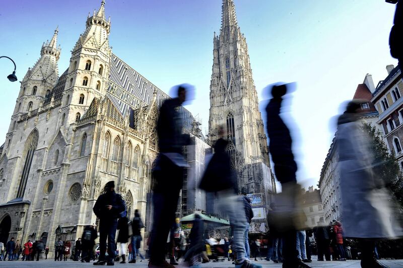 VIENNA, AUSTRIA - DECEMBER 05: Tourists walk by Domkirche St. Stephan on December 5, 2016 in Vienna, Austria. The town of Vienna is the federal capital of Austria as well as one of the nine federal states, the city has a population of 2.6 million citizens. (Photo by Alexander Koerner/Getty Images)