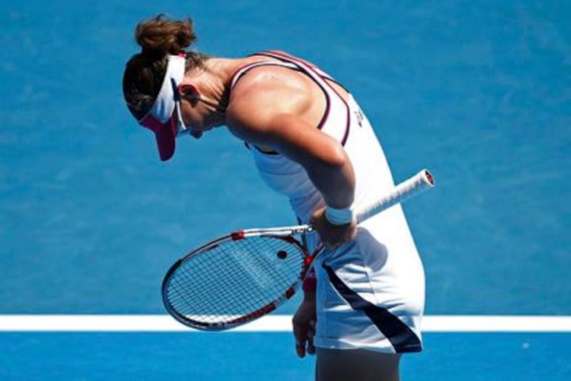Samantha Stosur of Australia reacts after losing a point to Sorana Cirstea of Romania during their women's singles match at the Australian Open tennis tournament in Melbourne January 17, 2012. REUTERS/Tim Wimborne (AUSTRALIA  - Tags: SPORT TENNIS)  