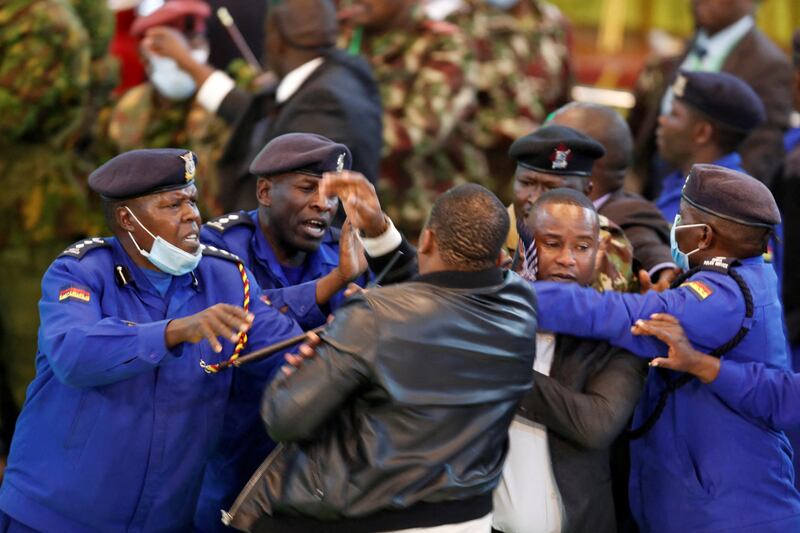 A protester and security officials scuffle before the announcement of the presidential election results, at the IEBC National Tallying Centre at the Bomas of Kenya, in Nairobi. Reuters