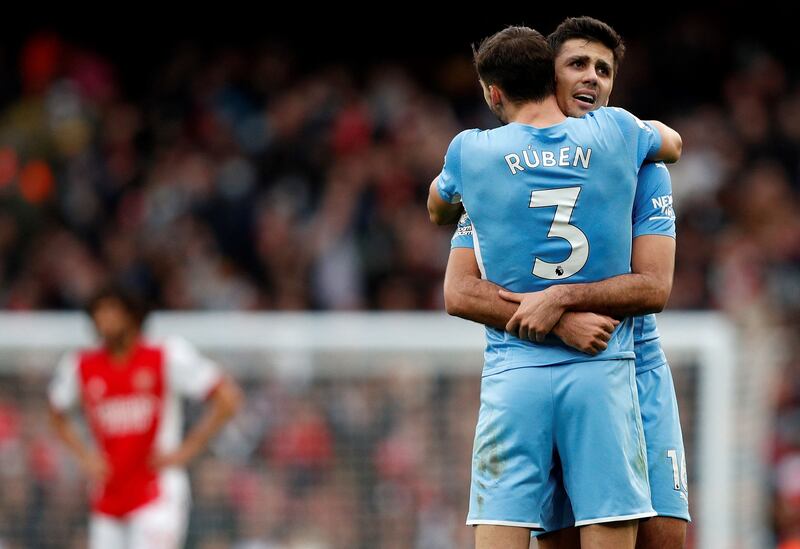 Manchester City midfielder Rodri celebrates with Ruben Dias after the win against Arsenal at the Emirates Stadium on January 1, 2022. AFP