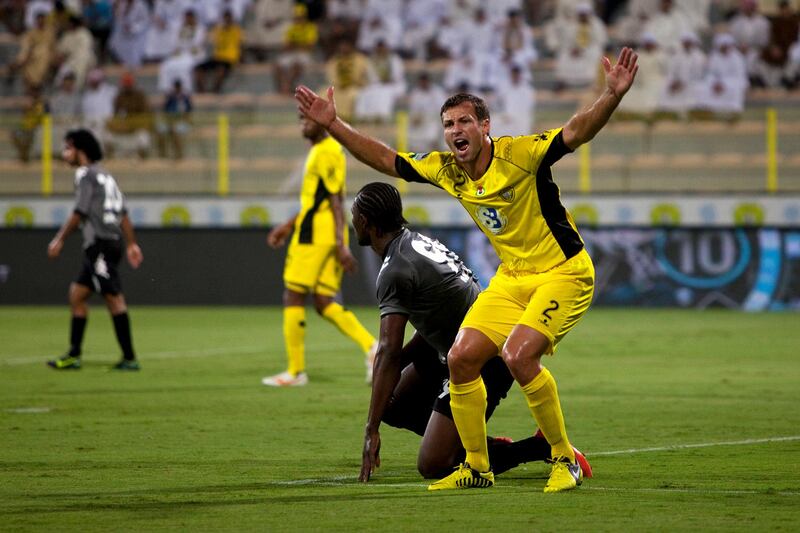 Dubai, United Arab Emirates, October 28, 2012:   Al Wasl's Lucas Neill, right, argues a call after being tackeld by Al Dhafra's Makhete Diop during the first half of their Pro League match at Zabeel Stadium in Dubai on October 28, 2012. Christopher Pike / The National