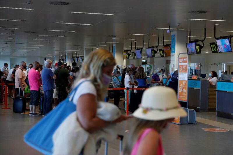 People wait in queues at Faro airport, in Faro, Portugal. Reuters