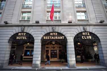 People walk past the Ritz hotel in central London. AFP
