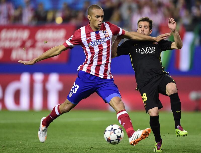 Atletico Madrid defender Joao Miranda vies with Barcelona defender Jordi Alba during their Champions League match on Wednesday. Javier Soriano / AFP / April 9, 2014