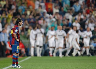 MADRID, SPAIN - MAY 07:  Lionel Messi of Barcelona stands dejected backdropped by celebrating Real Madrid players during the La Liga match between Real Madrid and Barcelona at the Santiago Bernabeu Stadium on May 7, 2008 in Madrid, Spain. Barcelona lost the match 4-1.  (Photo by Jasper Juinen/Getty Images)*** Local Caption *** Lionel Messi