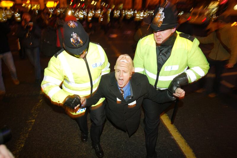 Police remove a protestor during a demonstration against the Iraq war in London