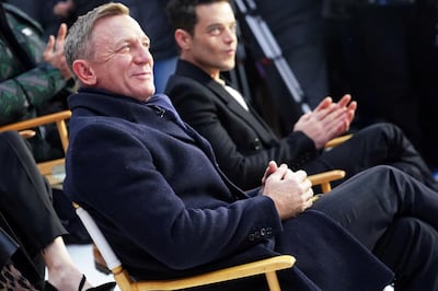 FILE PHOTO: Actors Daniel Craig and Rami Malek react during a promotional appearance on TV in Times Square for the new James Bond movie "No Time to Die" in the Manhattan borough of New York City, New York, U.S., December 4, 2019. REUTERS/Carlo Allegri/File Photo