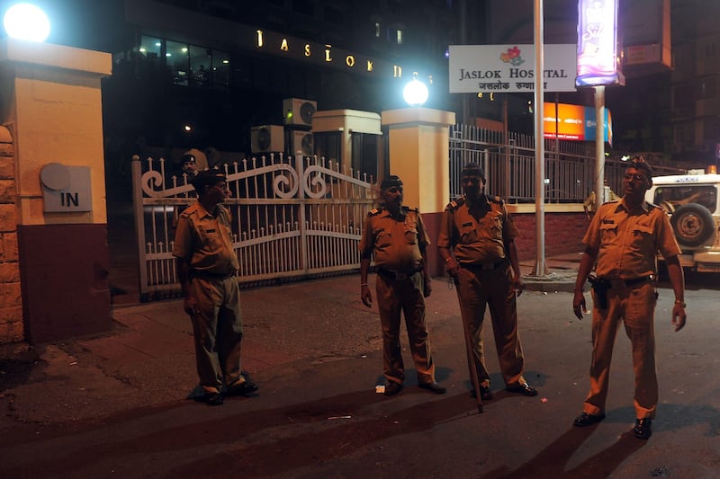 Policemen stand at the entrance gate to the city hospital where a gang rape victim is admitted, in Mumbai early morning on August 23, 2013. Five men gang-raped a woman photographer in India's financial hub Mumbai, police said August 23, stirring memories of a similar incident eight months ago in New Delhi which triggered nationwide protests.  AFP PHOTO/Indranil MUKHERJEE
 *** Local Caption ***  788260-01-08.jpg