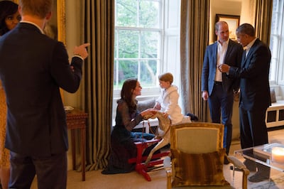 LONDON, ENGLAND - APRIL 22:   In this handout provided by The White House, President Barack Obama talks with the Prince William, Duke of Cambridge as Catherine, Duchess of Cambridge plays with Prince George as First Lady Michelle Obama talks with Prince Henry at Kensington Palace on April 22, 2016 in London, England.  The President and his wife are currently on a brief visit to the UK where they attended lunch with HM Queen Elizabeth II at Windsor Castle and later dinner with Prince William and his wife Catherine, Duchess of Cambridge at Kensington Palace. Mr Obama visited 10 Downing Street this afternoon and held a joint press conference with British Prime Minister David Cameron where he stated his case for the UK to remain inside the European Union.(Photo by Pete Souza/The White House via Getty Images)