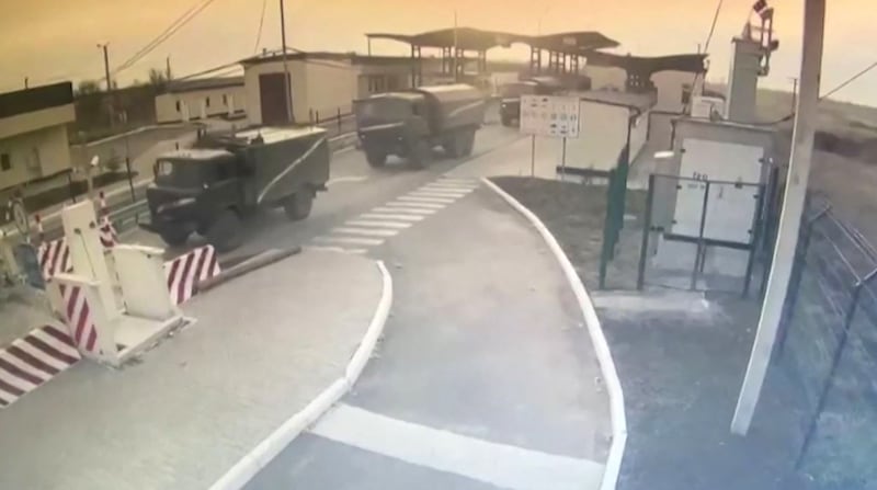 CCTV footage shows Russian military equipment crossing a Crimea border checkpoint on February 24, 2022. AFP